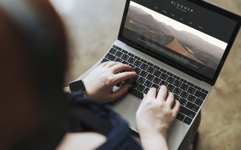 Blogger typing onto a computer screen